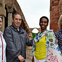 four teachers standing in front of ruins in India